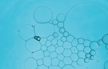 Serum oil droplets on water surface to create bubbles pattern and beauty wallpaper  background.