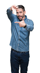Fototapeta premium Young handsome man over isolated background smiling making frame with hands and fingers with happy face. Creativity and photography concept.