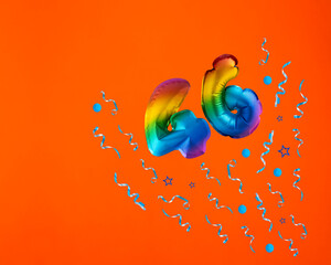 Confetti explosion with number 46 balloon - Celebration on orange background. Birthday card - obrazy, fototapety, plakaty