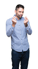 Young handsome man over isolated background Doing money gesture with hand, asking for salary...