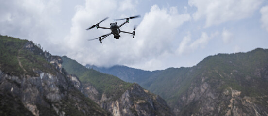 Fototapeta na wymiar Flying drone in high altitude mountains