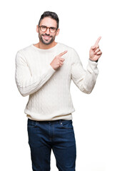 Young handsome man wearing glasses over isolated background smiling and looking at the camera...