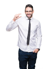 Young handsome business man wearing glasses over isolated background smiling and confident gesturing with hand doing size sign with fingers while looking and the camera. Measure concept.