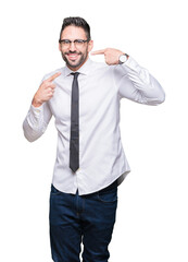 Young handsome business man wearing glasses over isolated background smiling confident showing and pointing with fingers teeth and mouth. Health concept.