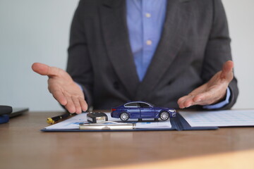 Fototapeta premium Agent Assurance Securing Deals with Confidence close up man working with car contract document or lease paper at desk in loan car office.