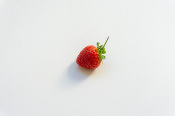 Red berry strawberry with leaves isolated on white background