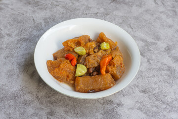 Sambal Goreng Krecek is a side dish to accompany opor or gudeg. It consists of krecek made from beef skin, petai, cowpea beans cooked with coconut milk and chili. Usually served during Eid al-Fitr