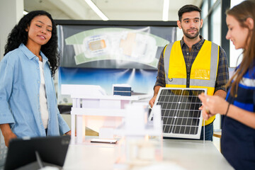 Architect and engineers wearing safety vests while analyzing solar power solutions over...