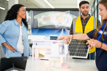 Architect and engineers wearing safety vests while analyzing solar power solutions over...