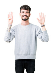 Young handsome man wearing sweatshirt over isolated background showing and pointing up with fingers...