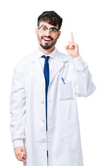 Young professional scientist man wearing white coat over isolated background pointing finger up with successful idea. Exited and happy. Number one.