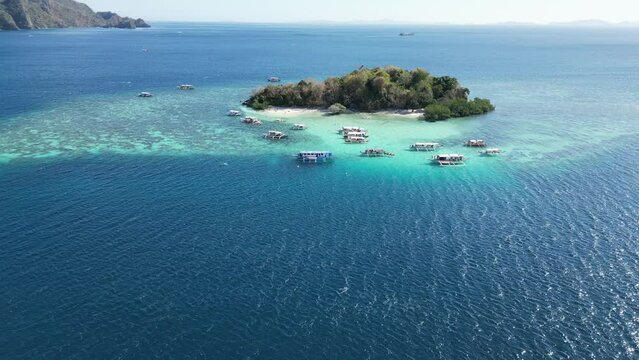 Drone Long Shot of CYC Island in Coron with Tour Boats at Reef on Sunny Day