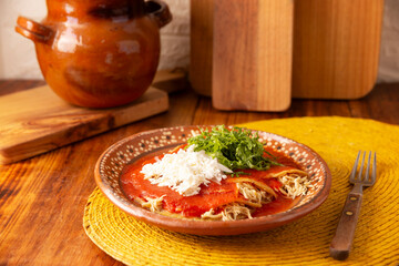 Entomatadas. Also known as Enjitomatadas, a typical dish of Mexican cuisine prepared with corn tortilla, tomato sauce and stuffed with shredded chicken meat. Classic homemade recipe. - 781743205