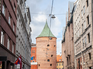 Panorama of a street of the old rica (vecriga) in latvia with a focus on the Riga powder tower, also called pulvertornis. It's a major landmark of the ancient riga.