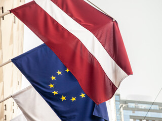 Flags of the European Union and latvia waiving together in the latvian city of Riga. Latvia is a...