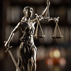 Legal Concept: Themis is the goddess of justice and the judge's gavel hammer as a symbol of law and order on the background of books