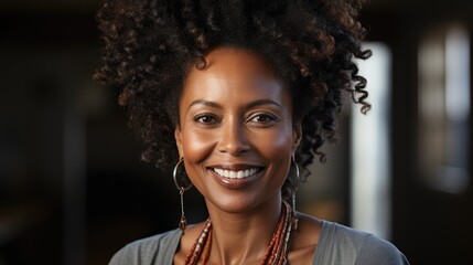 portrait of happy middle aged black woman on gray background.