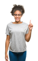 Young afro american woman wearing glasses over isolated background showing and pointing up with...