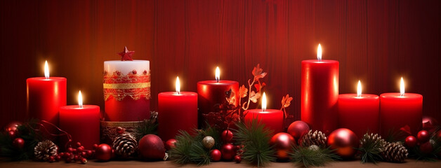 wide panoramic background banner image of red and gold Christmas candles and balls decor on textured color backdrop 