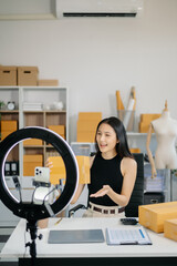 Startup small business SME, Entrepreneur owner woman using smartphone or tablet taking receive and checking online purchase shopping order