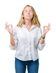 Beautiful young business woman over isolated background relax and smiling with eyes closed doing meditation gesture with fingers. Yoga concept.