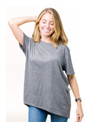 Fototapeta premium Beautiful young woman wearing oversize casual t-shirt over isolated background Dancing happy and cheerful, smiling moving casual and confident listening to music