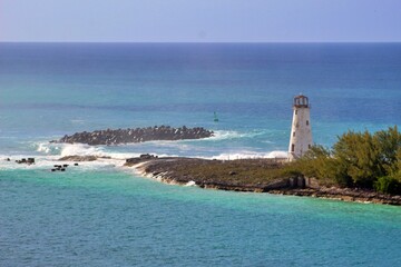 lighthouse stands on peninsula with the Caribbean sea in the background