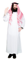 Arabian business man with long hair wearing traditional keffiyeh scarf Waiving saying hello happy and smiling, friendly welcome gesture