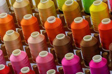 Close up the multi-color the group of industry bobbin thread.
