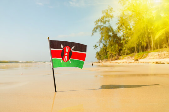 flag of Kenya on a beautiful clean white sand beach. The concept of recreation in the Kenyan Republic.