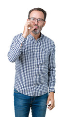 Handsome middle age elegant senior man wearing glasses over isolated background mouth and lips shut...