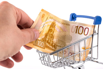 100 Russian ruble banknote in a miniature shopping cart