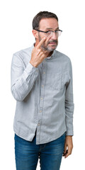 Handsome middle age elegant senior man wearing glasses over isolated background Pointing to the eye watching you gesture, suspicious expression