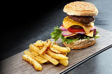 Beef, burger and fries on menu in restaurant with lettuce, tomato and cheese on bread in kitchen. Bbq, hamburger and fast food with meat, salad and potato chips in cafeteria diner for dinner or lunch