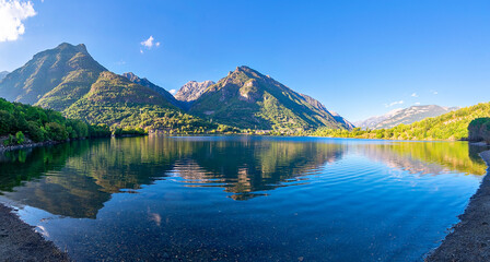 Panoramic view of the Eriste reservoir with the reflection of the mountains. Benasque Valley....