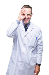 Middle age senior hoary professional man wearing white coat over isolated background doing ok gesture with hand smiling, eye looking through fingers with happy face.