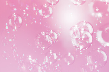 Beautiful Transparent Shiny Soap Bubbles Floating on Pink Background. Celebration Festive Backdrop. Pink Textured. Freshness Soap Suds Bubbles Water.
