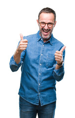 Middle age hoary senior man wearing glasses over isolated background success sign doing positive gesture with hand, thumbs up smiling and happy. Looking at the camera with cheerful expression.
