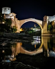 Mostar bridge at night reflected in the river. Bosnia