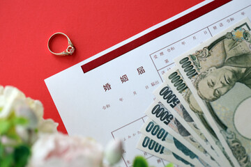 Japanese marriage registration blank document and wedding proposition ring and yen money on table...