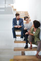 Talking, diversity and team on stairs in modern office for editing career with staff, artistic and...