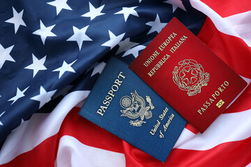 Passport of Italy with US Passport on United States of America folded flag close up