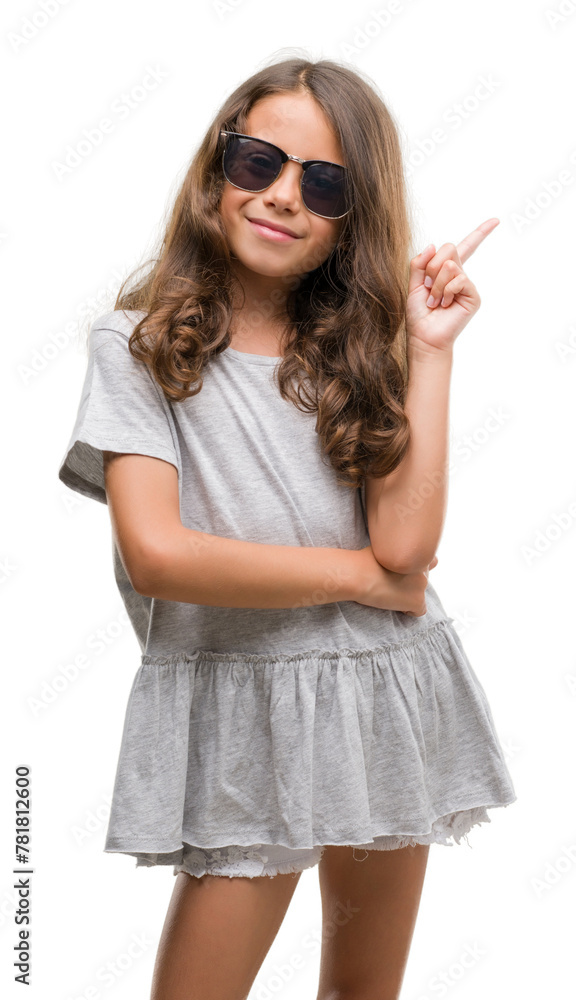 Canvas Prints brunette hispanic girl wearing sunglasses with a big smile on face, pointing with hand and finger to