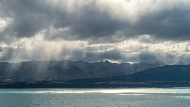 Lake Pukaki in New Zealand's South Island - dramatic time lapse with crepuscular rays shinning through the clouds