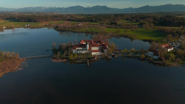 Famous Kloster Seeon monastery in Bavaria, Germany. catholic church on lake island. Alps mountains