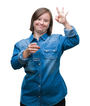 Young adult woman with down syndrome drinking water over isolated background doing ok sign with fingers, excellent symbol