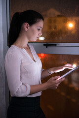 Woman, profile and tablet in office at night, web development and design for creative agency....