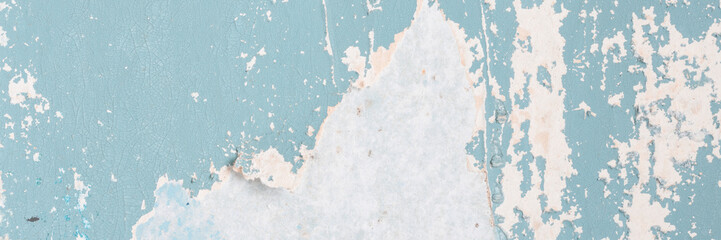 Peeling paint on the wall. Old concrete wall with cracked flaking paint. Weathered rough painted...
