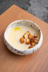 Tender cheese soup with olive oil and croutons