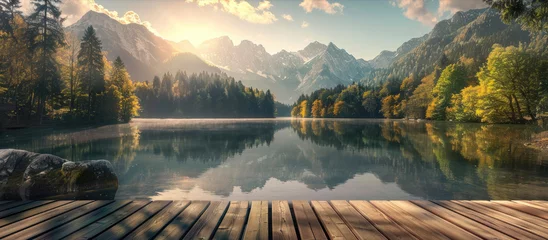 Fototapete Rund Wooden deck on the lake with the view of the mountains and forest at sunrise © Aleksandr Bryliaev